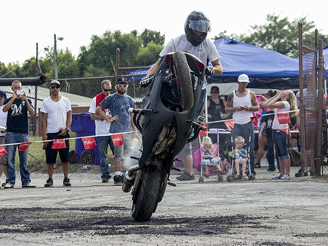 A rider pulls a wheelie during a 2013 Ride of the Century event in Columbia, Illinois.