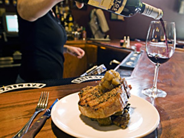 Pork out: A one-pound pork porterhouse served over kale, topped with apple compote.