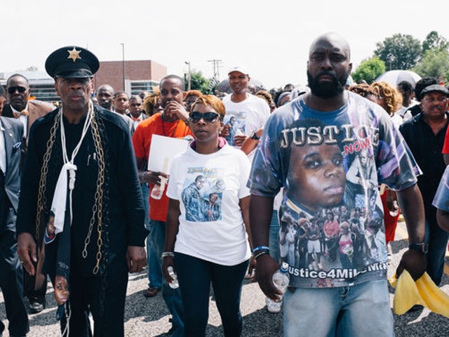 Lesley McSpadden, center, Michael Brown's mother, and Michael Brown Sr., right.