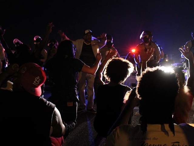 Protesters in Ferguson face police in riot gear in the days after Michael Brown's death.