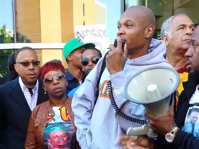 Eric Davis addresses a rally in Clayton in September with Michael Brown's mother, Lesley McSpadden.