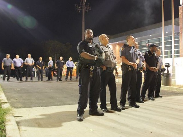 In this photo from late September, officers stand guard outside the Ferguson Police Department.