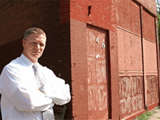 Gary Detmer in front of one of seven dilapitated properties he purchased with the help of Doug Hartmann and Lisa Krempasky. Detmer has sued Krempasky alleging forgery.
