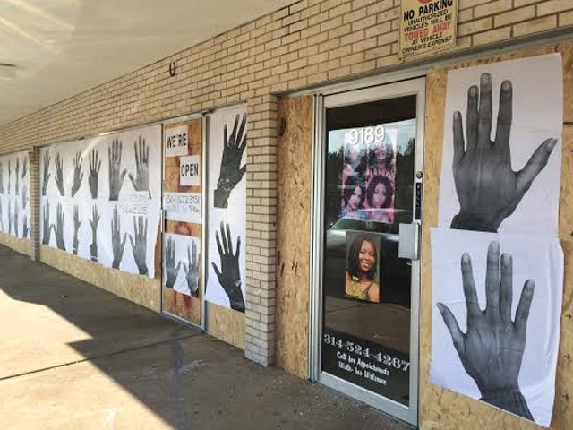 Businesses along West Florissant Avenue in Ferguson prepare for more protests by boarding up.