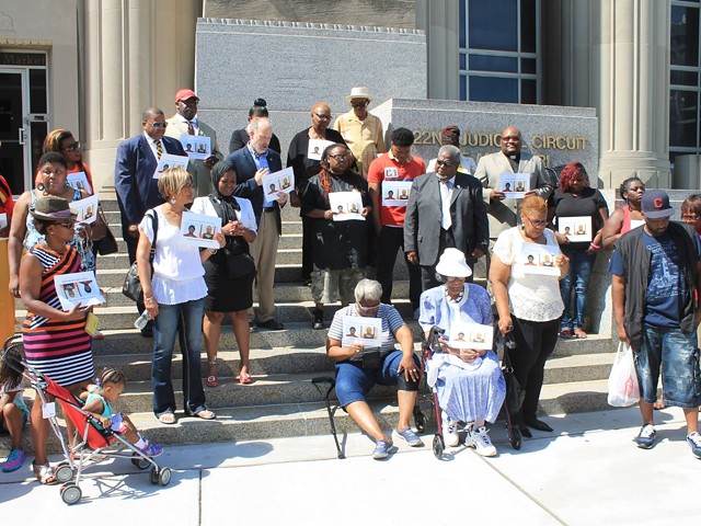 Family and supporters of Anthony Williams pray outside the Circuit Court building.