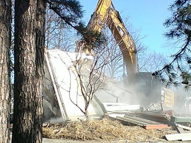 A bulldozer demolishes the Book House's old home in Rock Hill.