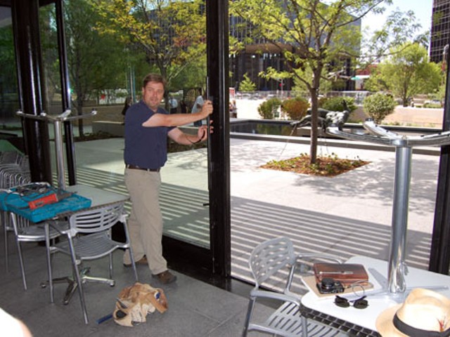 James Fiala, owner of Terrace View Cafe, gives the sliding door at the restaurant a test-opening.