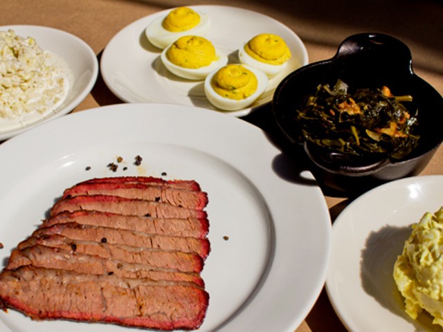 Smoked brisket with sides of cole slaw, deviled eggs, bacon braised greens and potato salad.