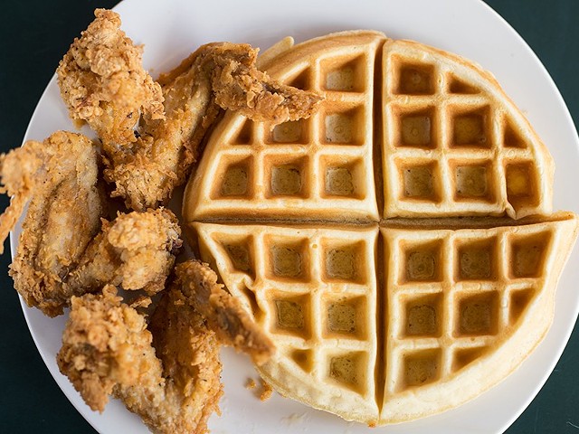An offering of chicken and waffles pairs three chicken wings with a Belgian waffle.