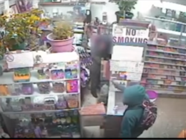 A robber in a green hoodie pulls a gun on a 63-year-old clerk at Asian World Market.