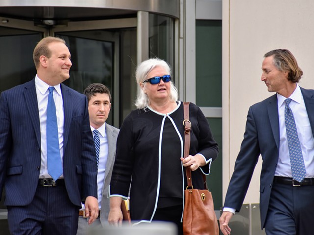 Sheila Sweeney leaves federal court with her attorneys after pleading guilty in a public corruption case.