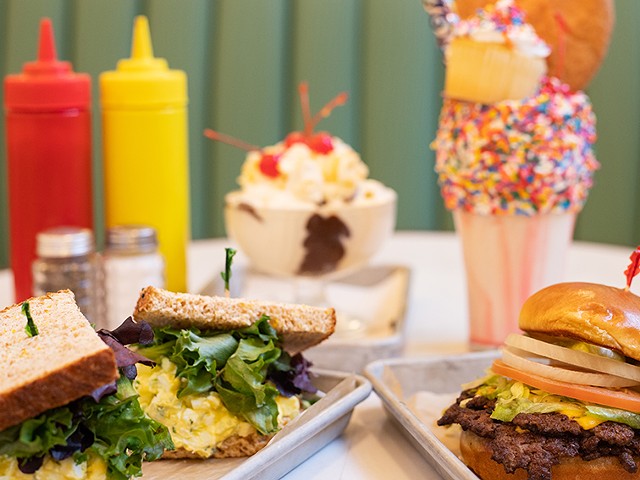 A selection of items from the Soda Fountain, pictured from left to right, top to bottom: egg salad sandwich, double cheeseburger, All-American Sundae and A Very Happy Un-Birthday Freak Shake.