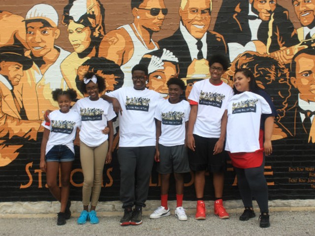 The kids from the Boys and Girls Club pose with the new St. Louis Wall of Fame they created.