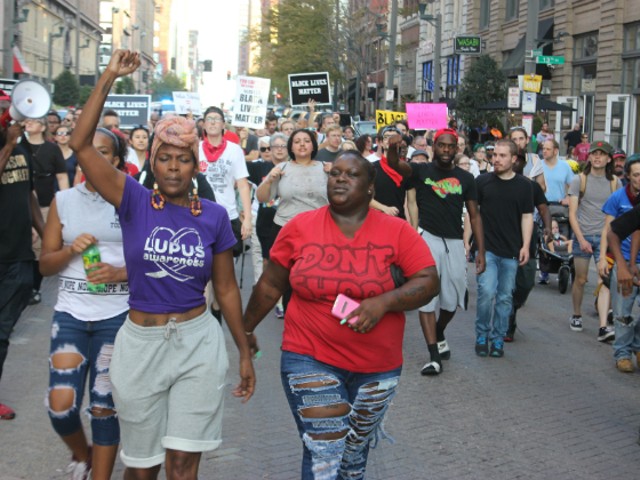 Melissa McKinnies (left) and Ebony Williams lead protesters along Washington Avenue.