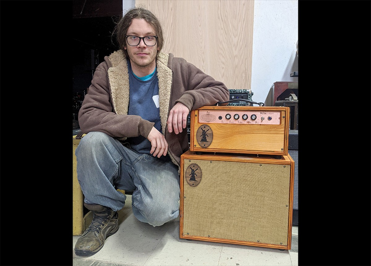Justin Mills poses with one of his creations, a 50 watt Atlas amplifier with a 1x12 cabinet.