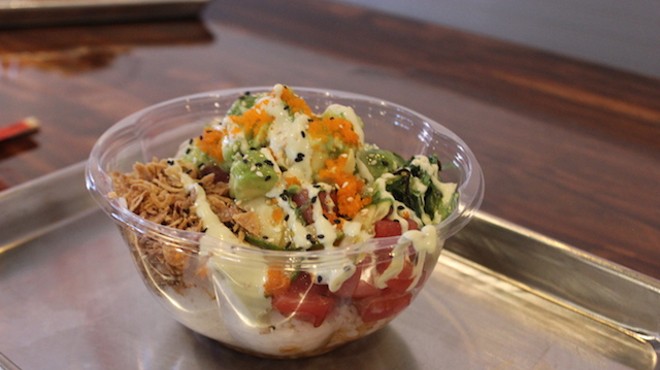A medium-sized tuna bowl topped with avocado, fried onions, wasabi sauce and roe.