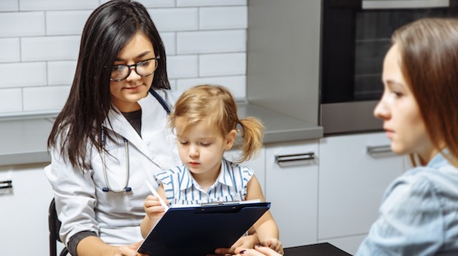 A pediatrician examines a patient — something that will be less frequent with the loss of the Children's Health Insurance Program, or CHIP.
