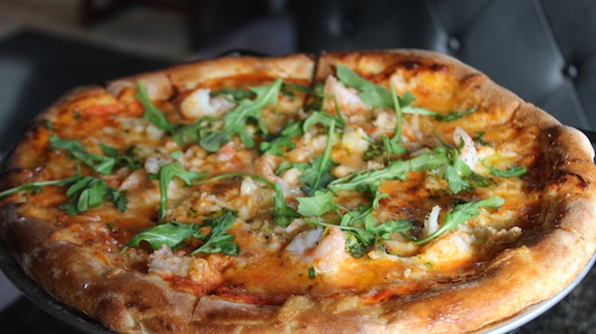 The lobster and shrimp pizza is topped with both shellfish and an orange-tarragon gremolata.