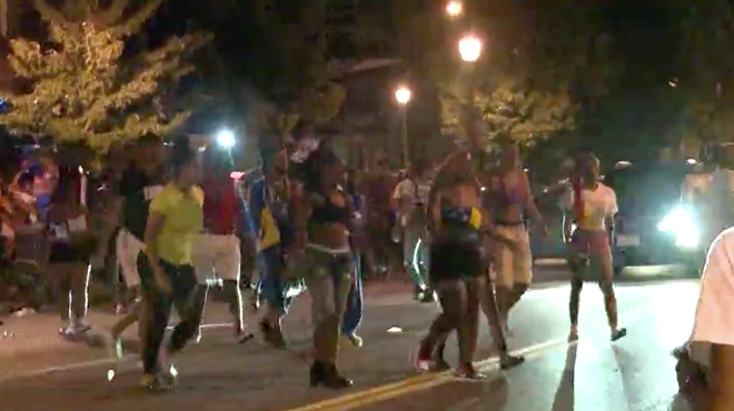 A KSDK cameraman films people fleeing as police disperse crowds in the Grove.