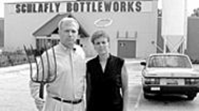 Tom Schlafly stands in of his Maplewood bottling 
    facility with Ann Haubrich, member of the Art Outside 
    organizing committee.