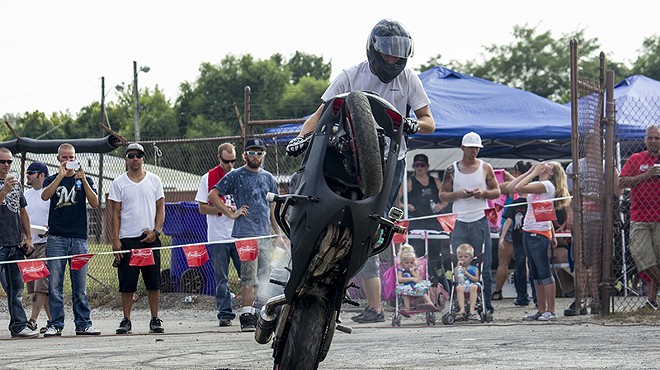 A rider pulls a wheelie during a 2013 Ride of the Century event in Columbia, Illinois.