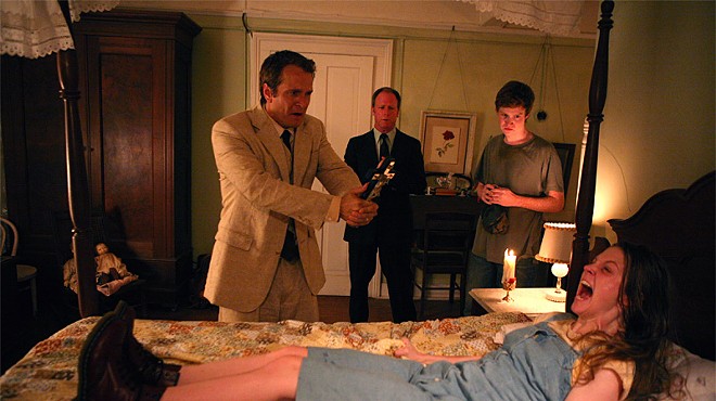Your mother sews socks that smell: Ashley Bell (front), Patrick Fabian, Louis Herthum, and Caleb Landry Jones in The Last Exorcism.