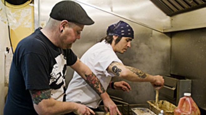 Jimmy Hippchen (left) cooks with chef Jaxon Noon.