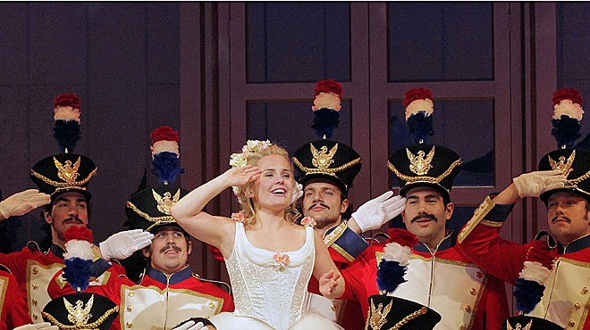 Ashley Emerson surrounded by the cast of OTSL's The Daughter of the Regiment.