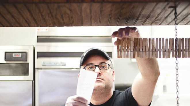 Chris Makos, one of the owners of Boodles, reading orders behind the counter. See a slideshow of Boodles BBQ.