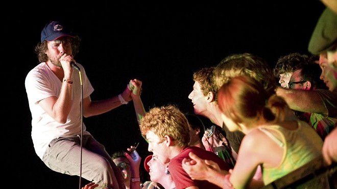 Kevin Drew of Broken Social Scene jumping into the crowd during last year's LouFest in Forest Park.
