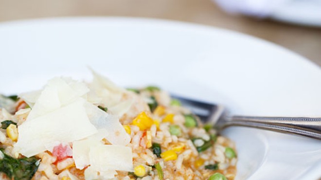 Risotto Del Giorno - a roasted Georgia corn, sweet red bell pepper puree, English Peas, baby arugula, shrimp, and shaved parmigiano risotto