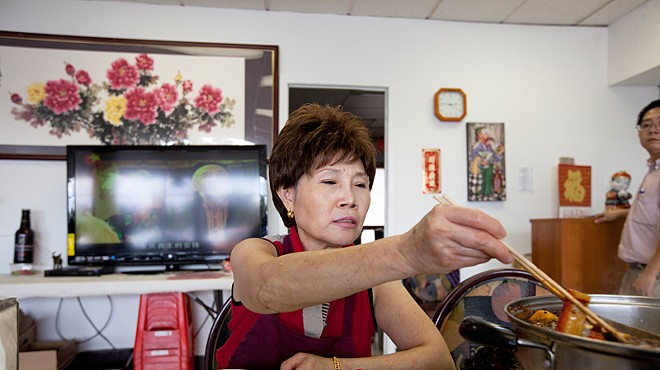 Xin Lin, owner of Famous Szechuan Pavilion, sitting down for a moment to enjoy a Hot Pot lunch.  See a complete gallery of Jennifer Silverberg photographs of Famous Szechuan Pavilion here.