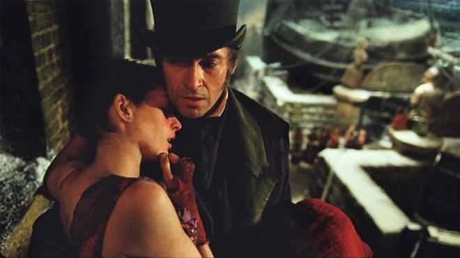 Les Miserables stays true to itself onscreen. A very ill Fantine (Anne Hathaway) is held by Jean Valjean (Hugh Jackman).