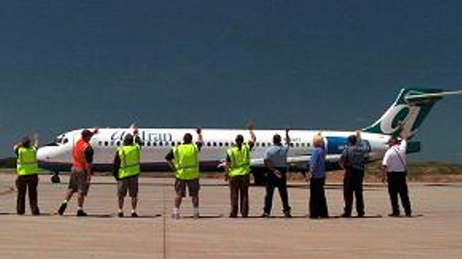 Airport employees practice the "Branson Wave."