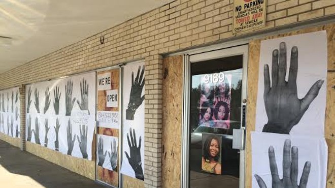 Businesses along West Florissant Avenue in Ferguson prepare for more protests by boarding up.