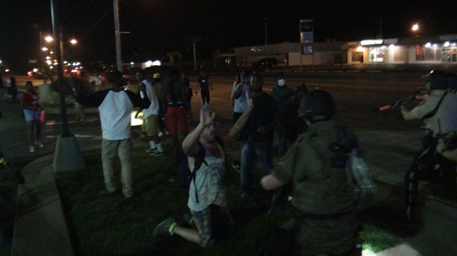 Police get ready to make an arrest Tuesday in Ferguson.