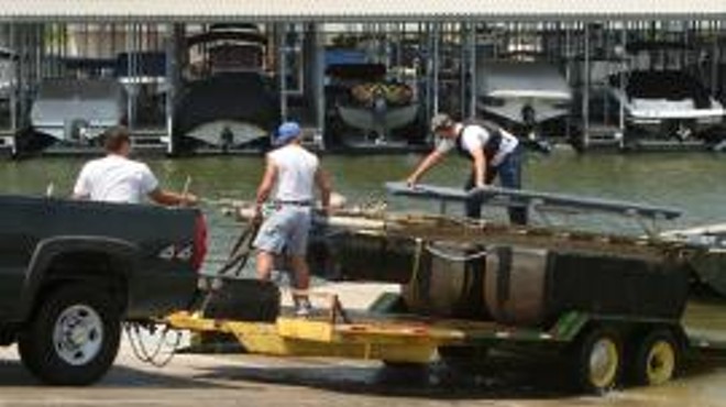 Bad news! Agents remove a guy's boatlift that had an invasive species attached to it.