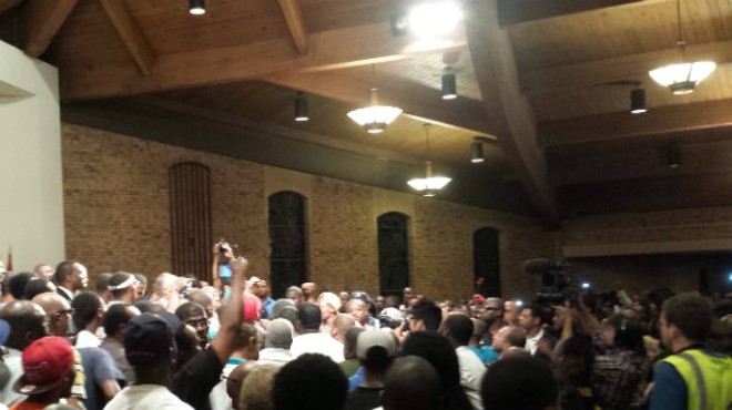 Rev. Al Sharpton surrounded by young men on stage at Greater St. Mark's Missionary.