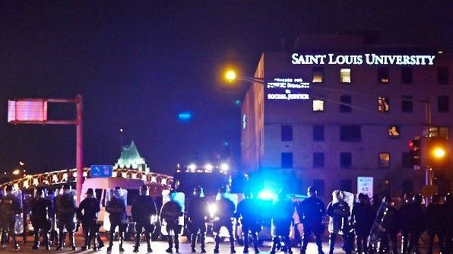 St. Louis police in riot gear block South Grand Boulevard shortly after protesters shut down Interstate 44. See more photos here.