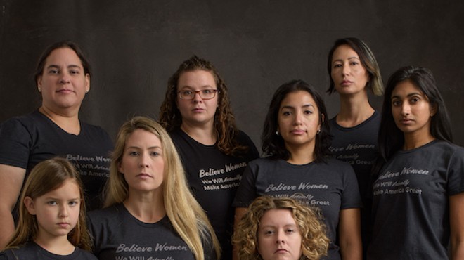 Amanda Gray-Swain, seated center, surrounded by women wearing her T-shirt design.