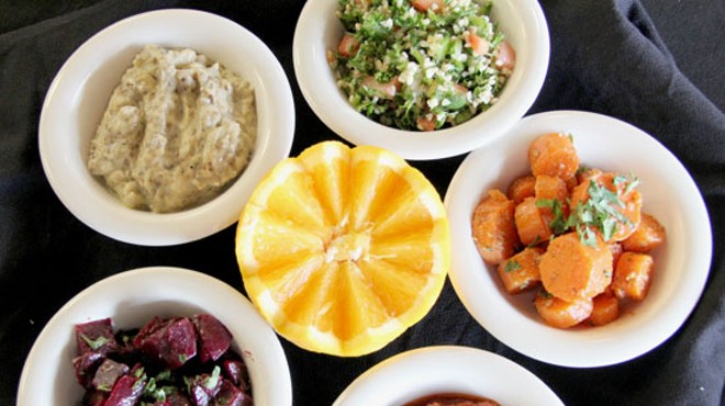 An assortment of Mediterranean salads and dips, including Harir's tabbouleh