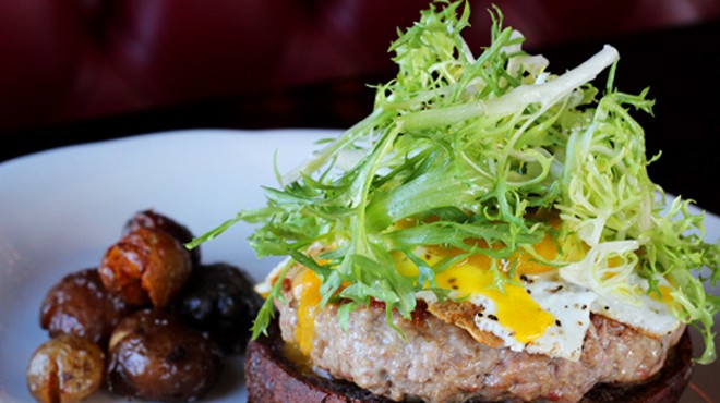 Duck burger on a pumpernickel bun with five-year gouda, a fried duck egg and frisee.