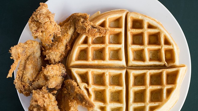 An offering of chicken and waffles pairs three chicken wings with a Belgian waffle.