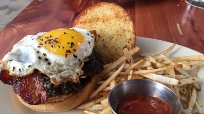 The Farmhouse Burger — two smashed patties, topped with bacon and a peppery eggs.