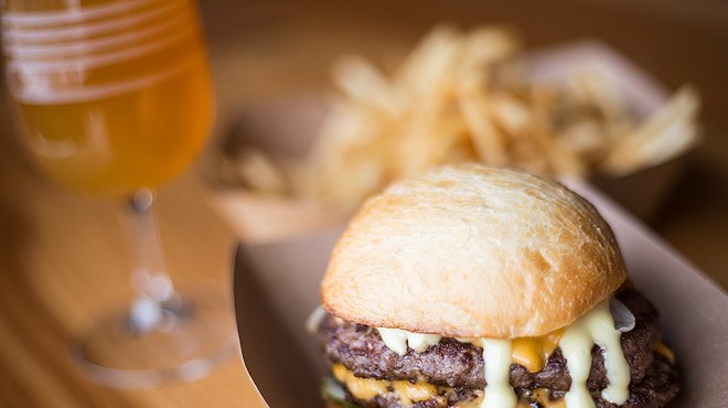 The burger is topped American cheese, pickles and dijonnaise and served on a brioche bun.
