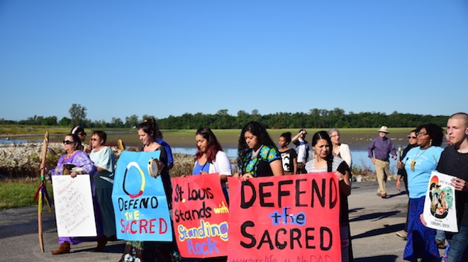 A peaceful march makes its way along the Mississippi River after water walker Saundi Kloeckener led a water ceremony advocating #NoDAPL.