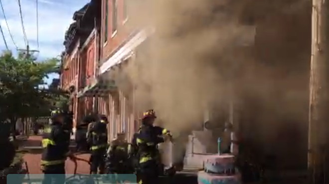 Firefighters work to put out a fire at Sweet Divine in Soulard.