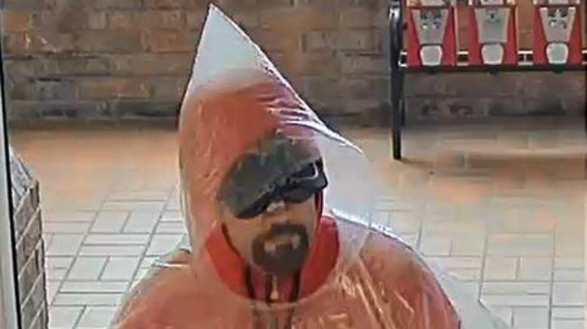 A poncho-wearing robber on Sunday holds up a Collinsville bank.