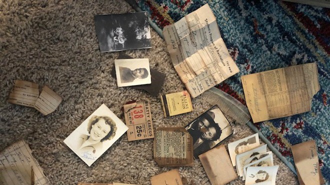 These items were found in wallets wedged into a brass vent cover behind a toilet in Centralia, Illinois.