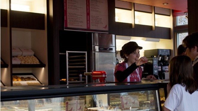 A worker greets customers at Piccione Pastry in 2013.